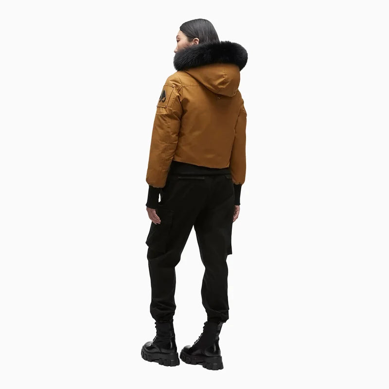 model showing the back of the Debbie winter coat premium Moose Knuckle winter coat, big pom poms on the hood, fur hood, secondhand, like new 