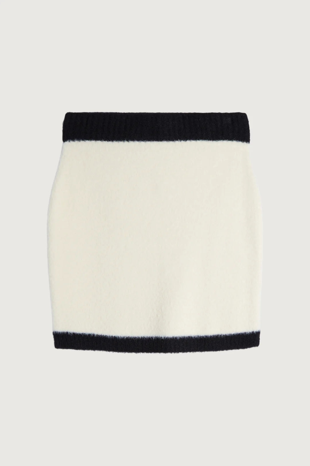 A white knit Oak + Fort mini skirt with black ribbed trim at the waistband and hem, shown flat against a light gray background. Women's consignment. Sherwood Park Store